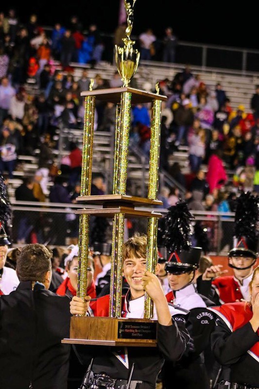 A photo of myself after winning my first state championship, holding the first place trophy.